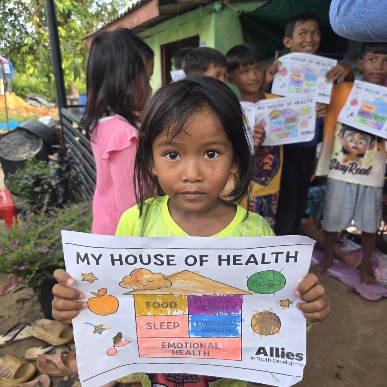 Child holding Allies House of Health lesson page