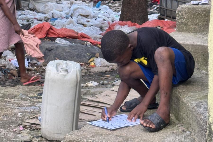 A child doing AMP activity beside a landfill