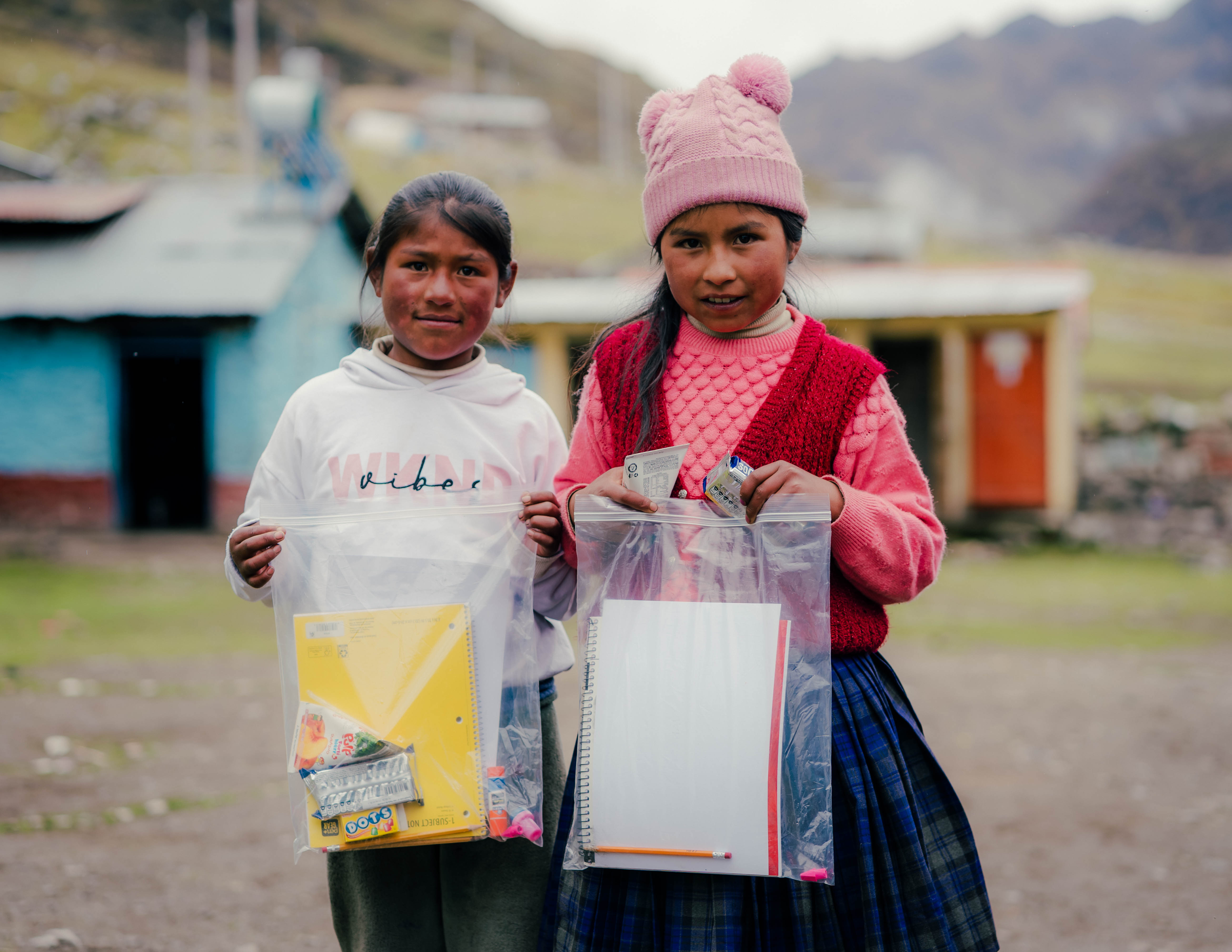 Children receiving school supply kits