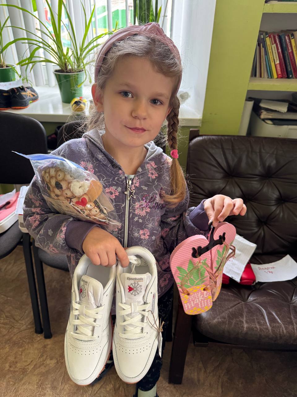 Girl receiving shoes through collection drive