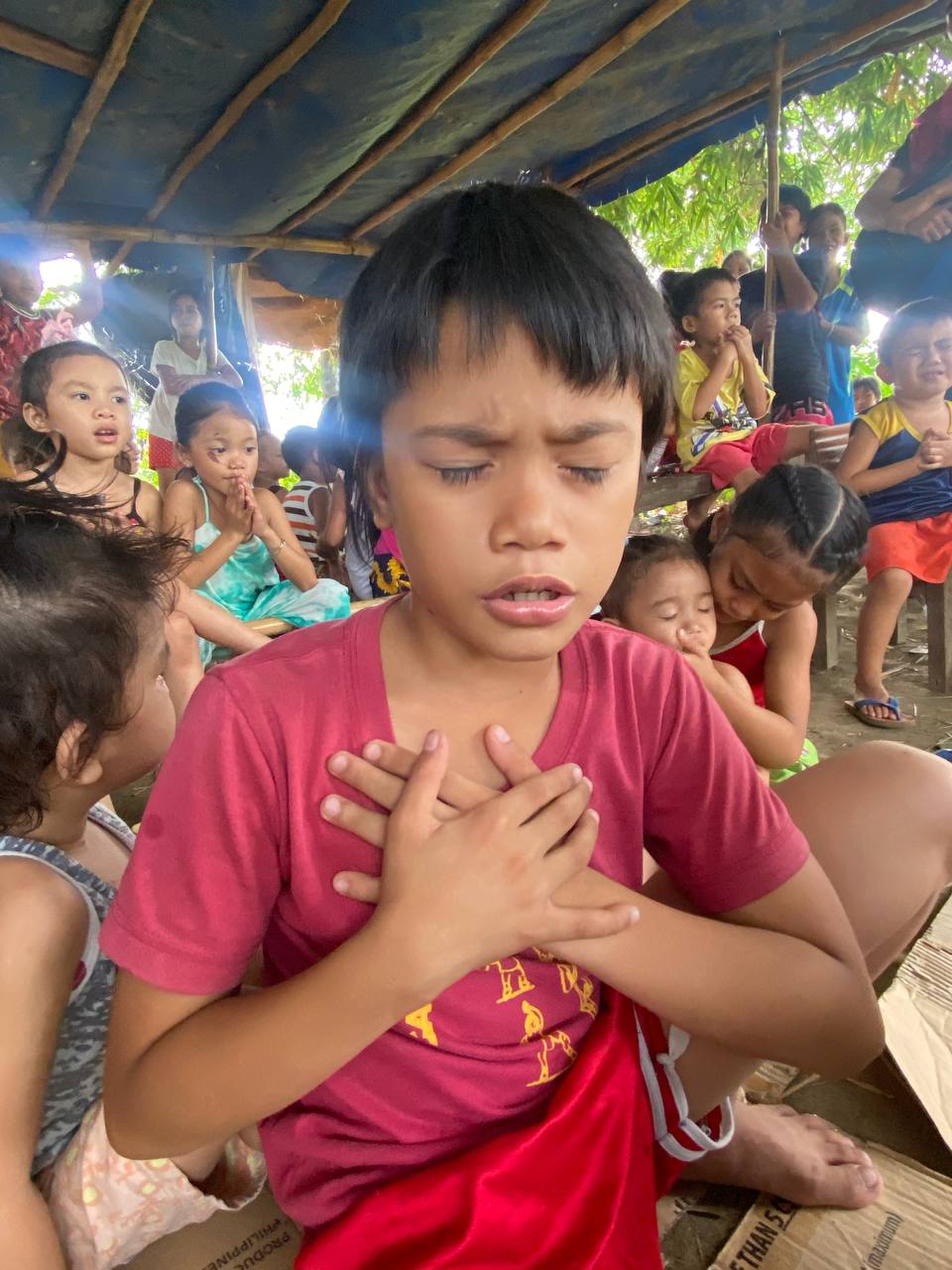 Boy praying in the Philippines