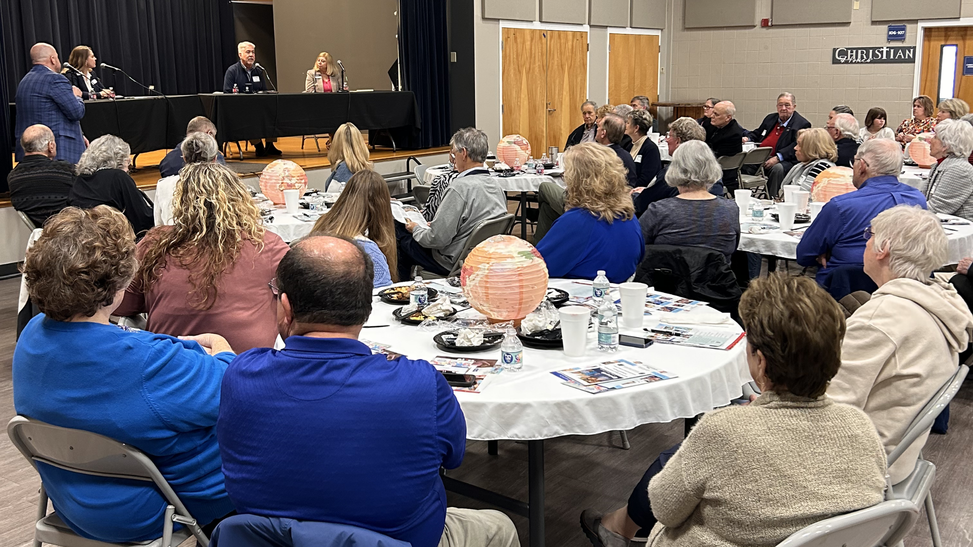 Panel leaders sharing insights on foster care and orphan care